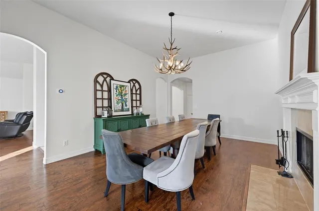 a view of a dining room with furniture wooden floor and a chandelier