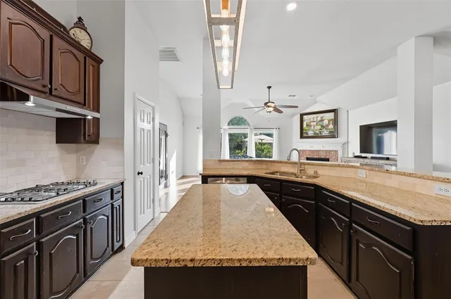 a kitchen with stainless steel appliances granite countertop a stove and a sink