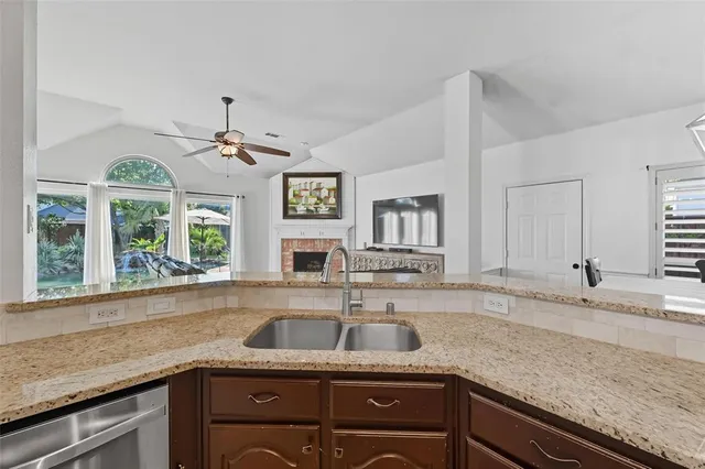 a view of a backyard with plants and a fence