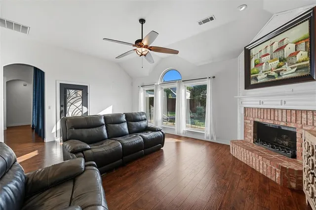 a living room with furniture and a wooden floor