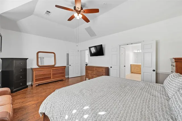 a spacious bedroom with a bed and a couch