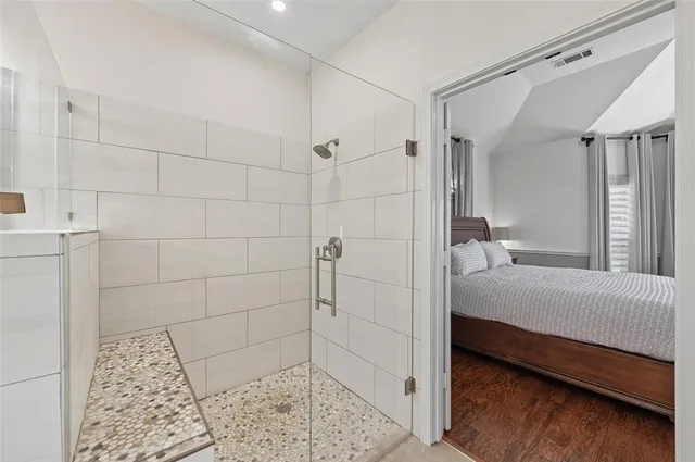 a spacious bathroom with a double vanity sink a large mirror and a bathtub