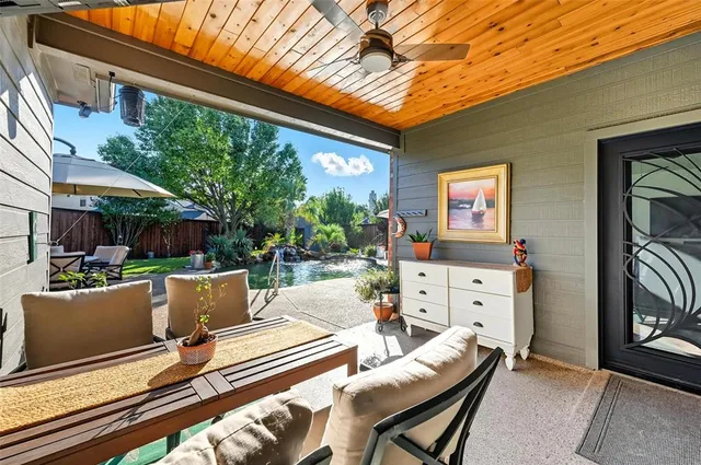 a view of a patio with table and chairs and potted plants