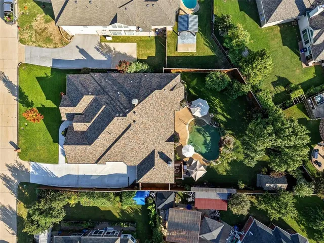 an aerial view of a house with garden space and outdoor seating