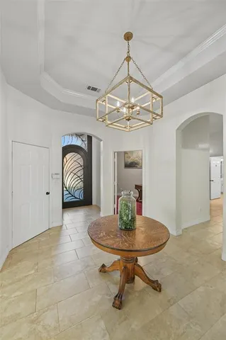 a view of a room with chandelier table and chairs