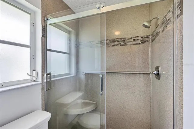 a bathroom with a shower and toilet