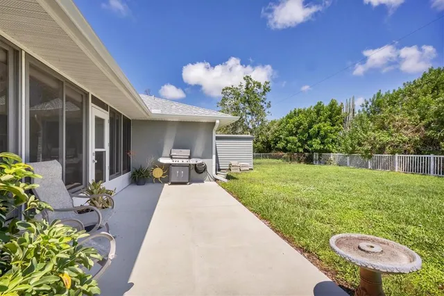 a view of a house with backyard and sitting area