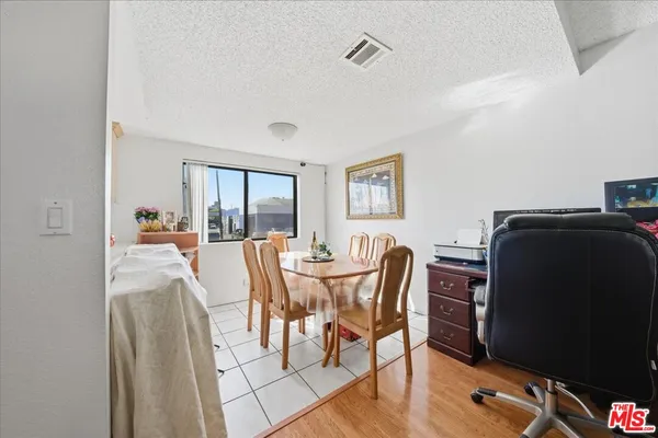 a dining room with furniture and window