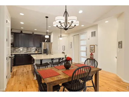 a group of people sitting in a kitchen and dining room