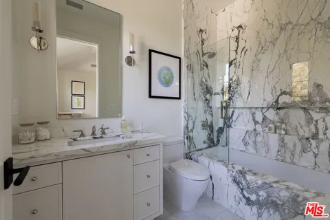 a bedroom with a bed and a mirror