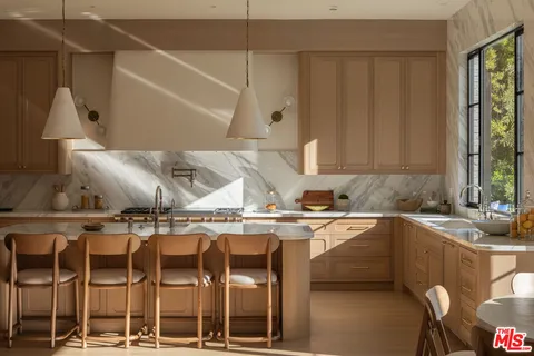a kitchen with a sink a window and cabinets