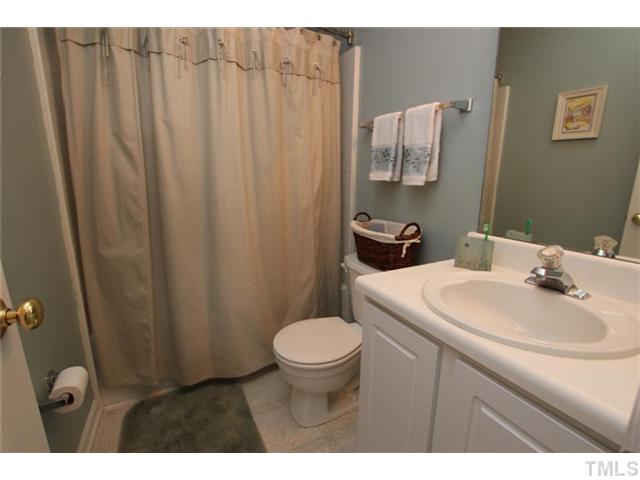 3812 Hopper Street Raleigh, NC 27616 - Photo 13 of 19 a bathroom with a sink a toilet and mirror