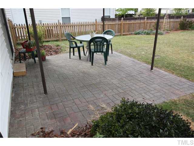 3812 Hopper Street Raleigh, NC 27616 - Photo 17 of 19 a view of a patio with a table and chairs