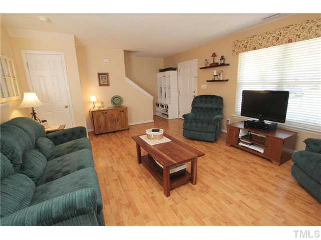 3812 Hopper Street Raleigh, NC 27616 - Photo 3 of 19 a living room with furniture a flat screen tv and a window