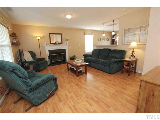 3812 Hopper Street Raleigh, NC 27616 - Photo 4 of 19 a living room with furniture and a fireplace