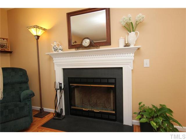 3812 Hopper Street Raleigh, NC 27616 - Photo 5 of 19 a living room with a fireplace and a potted plant