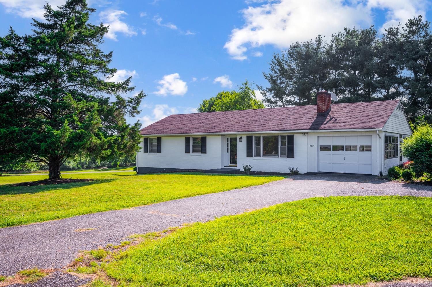a front view of a house with a yard and swimming pool