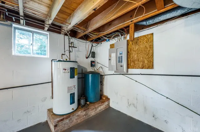 a view of storage and utility room with refrigerator and window