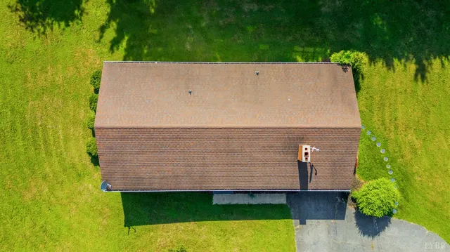 an aerial view of a swimming pool with a yard