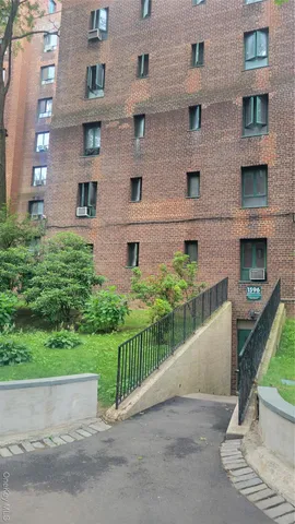 a front view of a house with a garden and plants