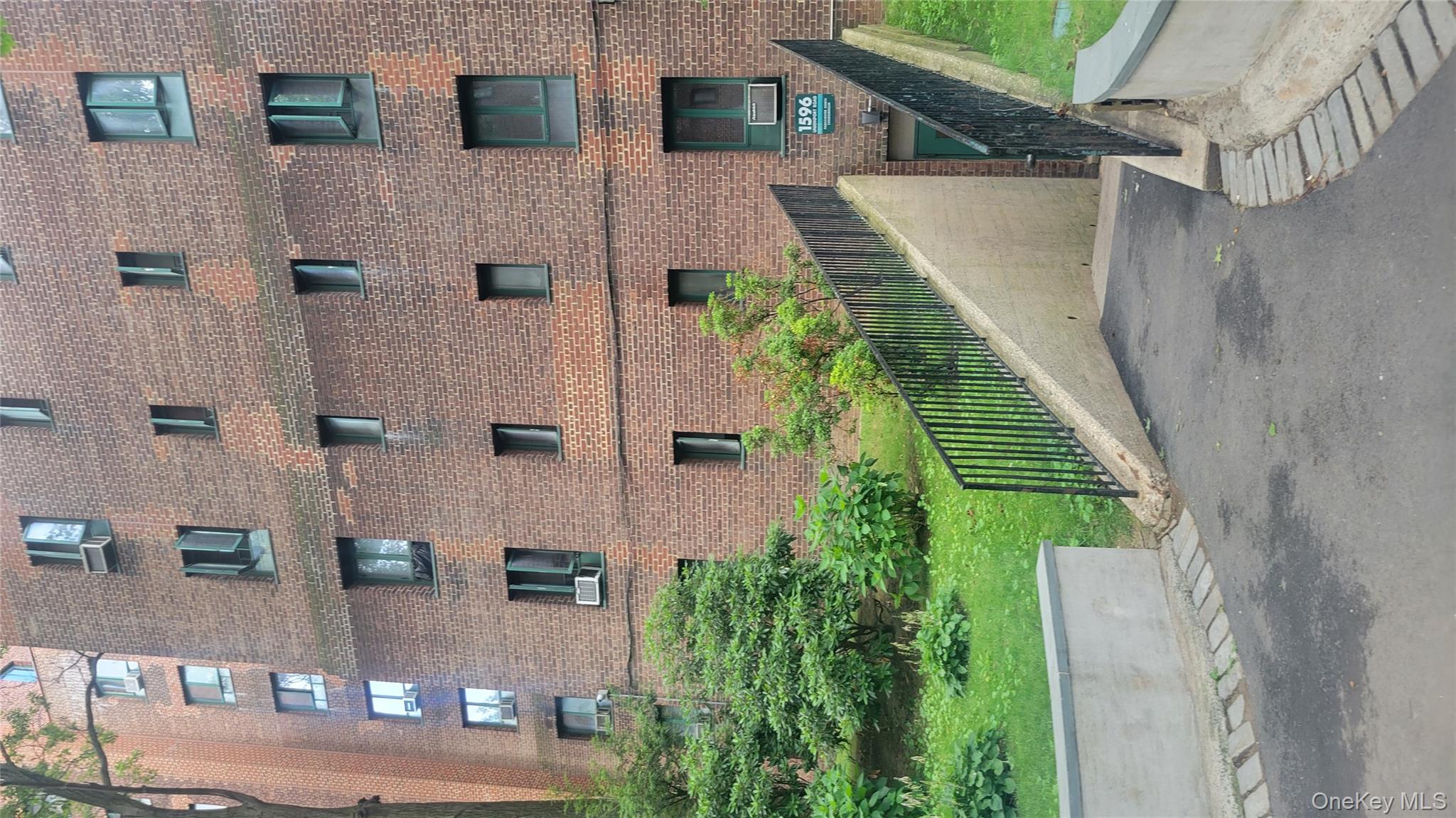 a front view of a house with a garden and plants