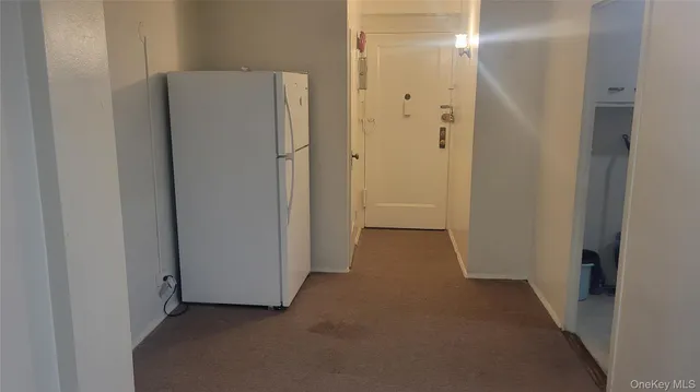 a view of a room with a refrigerator