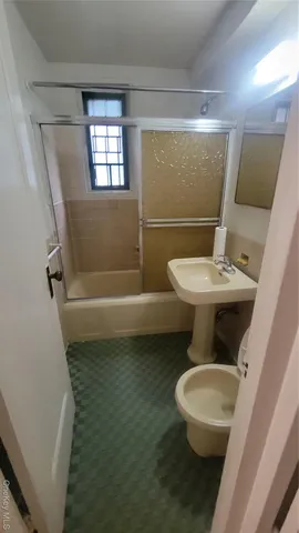 a white toilet sitting next to a bathroom sink and tub