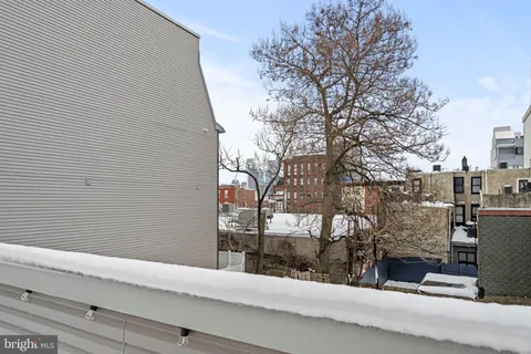 a view of a house with a snow on the road