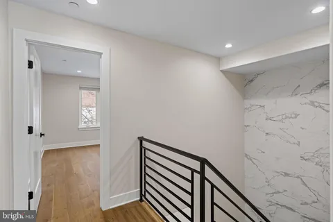 a view of a hallway with wooden floor