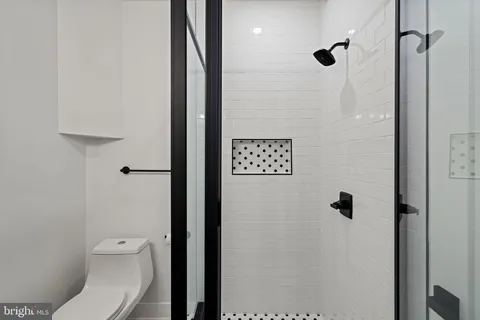 a bathroom with a toilet and a shower