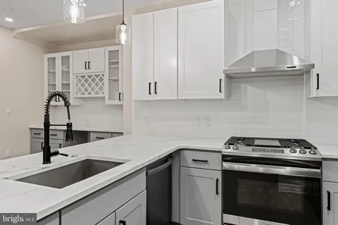 a kitchen with a sink stove and cabinets
