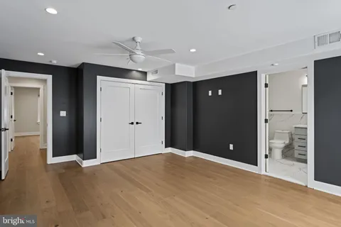 a view of an empty room with wooden cabinet