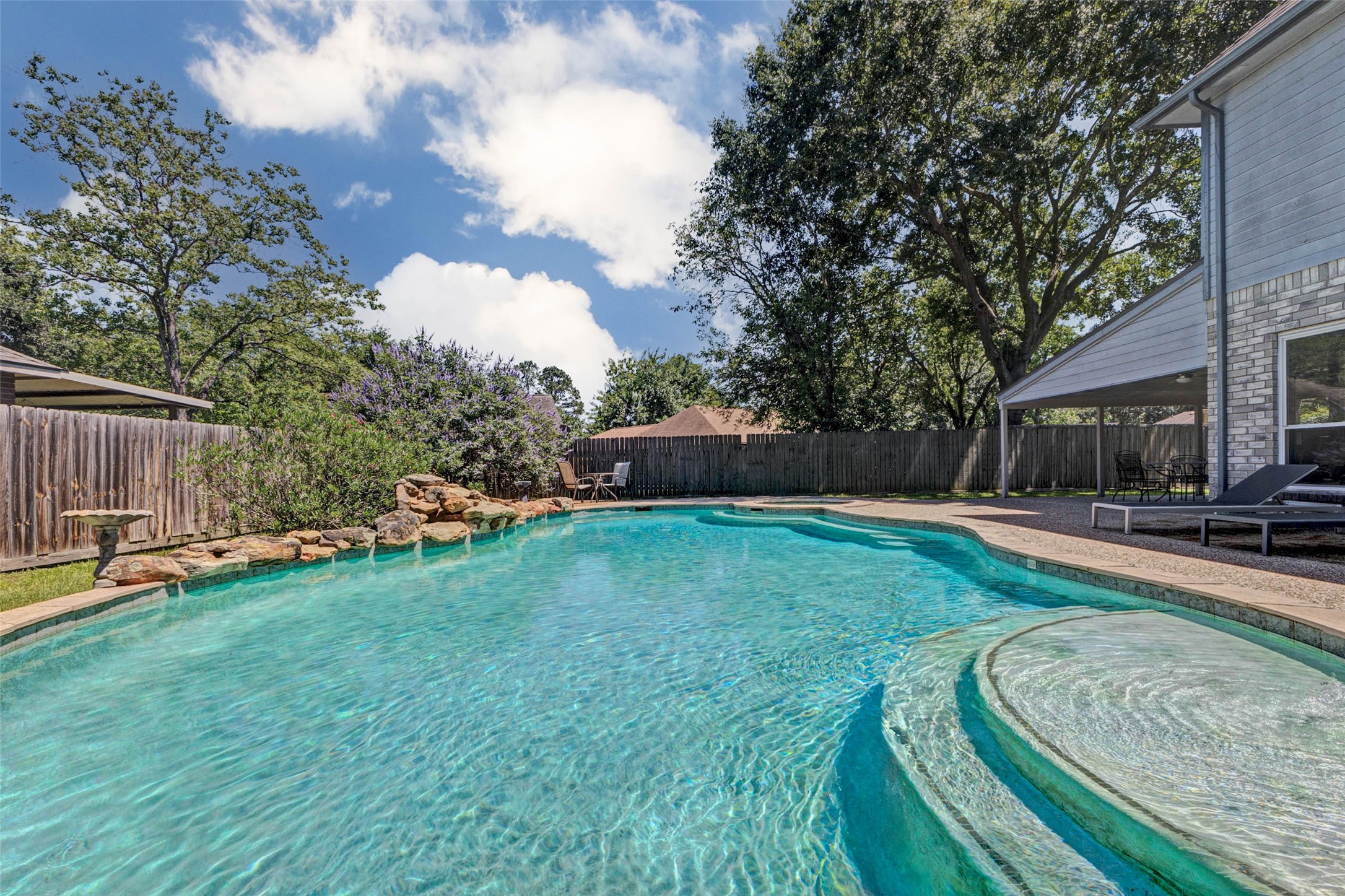 9215 Landry Boulevard Spring, TX 77379 - Photo 36 of 42 Just in time for summer, this sparkling pool is ready to impress with expansive swim space, a relaxing tanning ledge, and beautiful rock waterfall accents.
