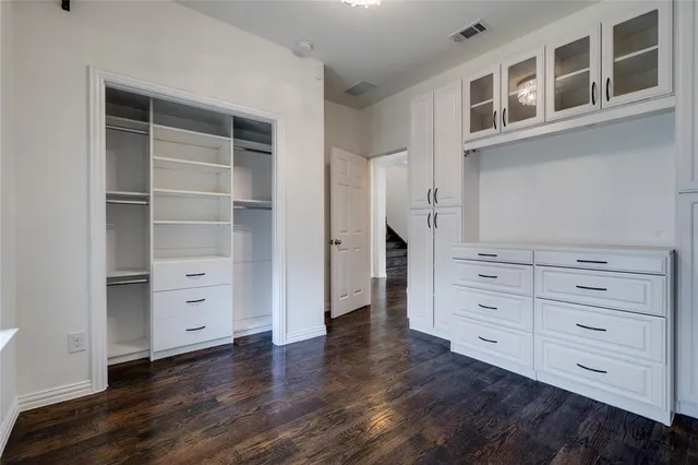 a view of an empty room with cabinet and a window