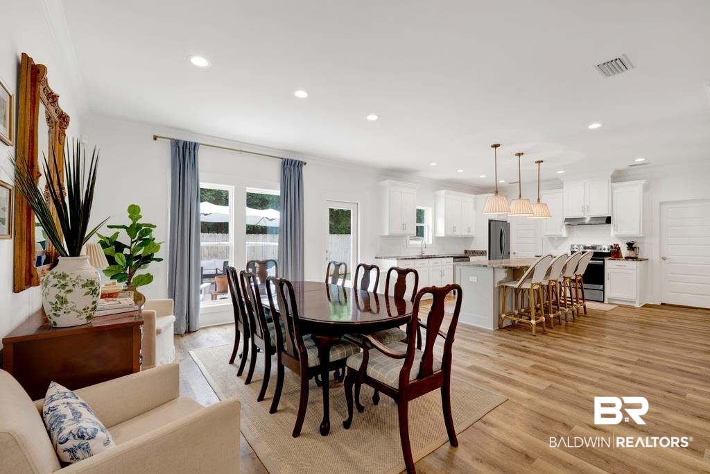 379 Pecan Ridge Boulevard Fairhope, AL 36532 - Photo 8 of 21 Open-concept living space featuring wood-finish flooring, recessed lighting, and a white color palette