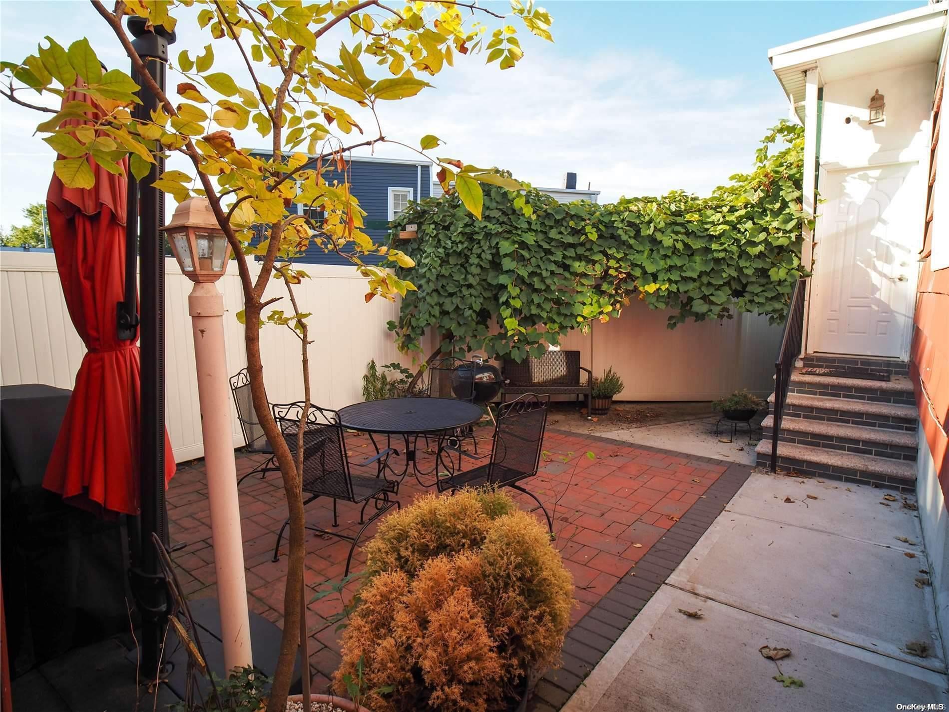 a backyard of a house with table and chairs