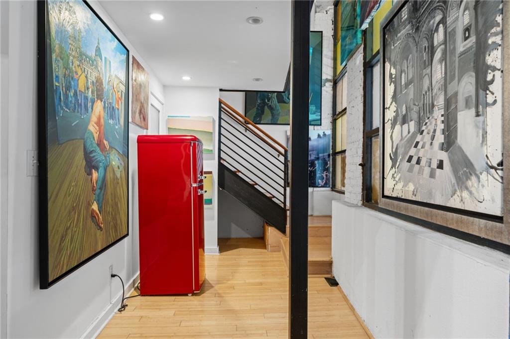 161 Mangum Street Southwest, Unit 102 Atlanta, GA 30313 - Photo 14 of 48 a view of a hallway with paintings on the wall