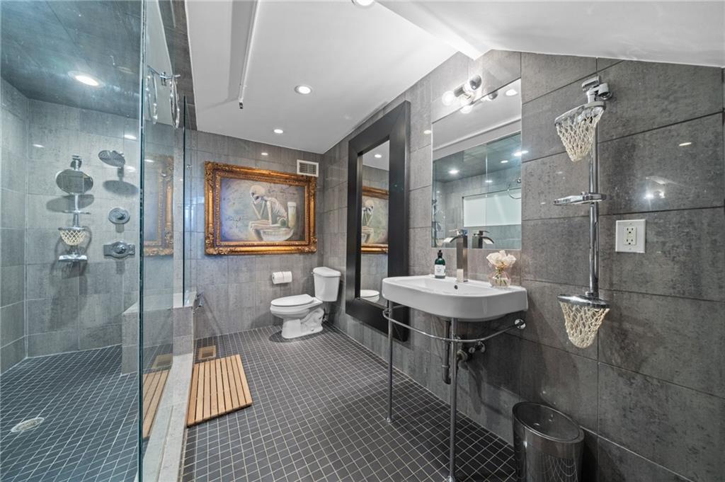 161 Mangum Street Southwest, Unit 102 Atlanta, GA 30313 - Photo 15 of 48 a spacious bathroom with a shower sink and mirror