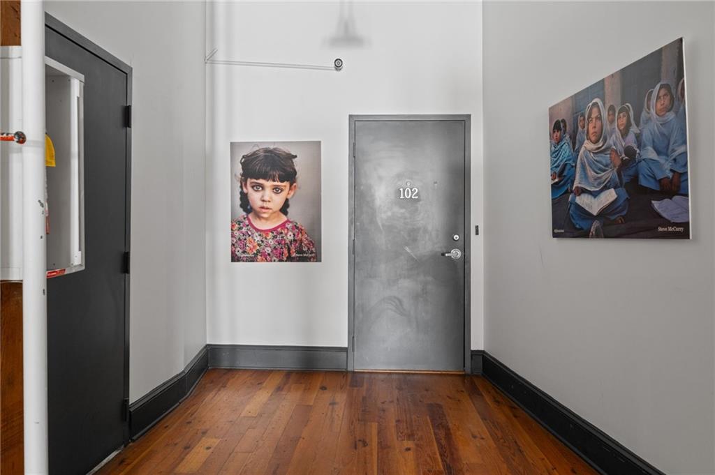 161 Mangum Street Southwest, Unit 102 Atlanta, GA 30313 - Photo 2 of 48 a view of a hallway with wooden floor