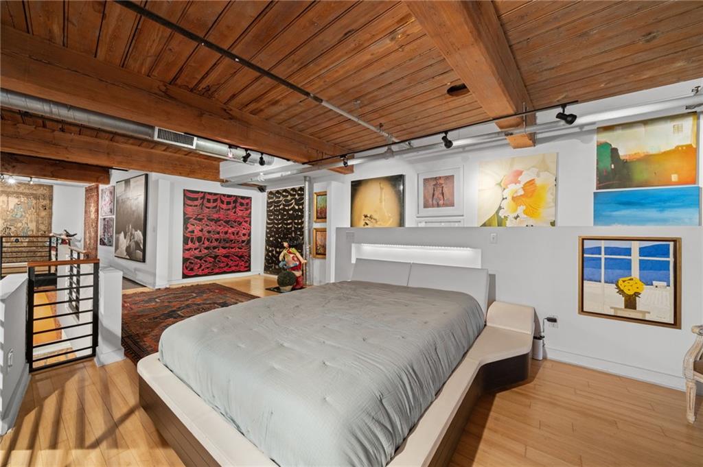 161 Mangum Street Southwest, Unit 102 Atlanta, GA 30313 - Photo 35 of 48 a bed room with a bed and a couch