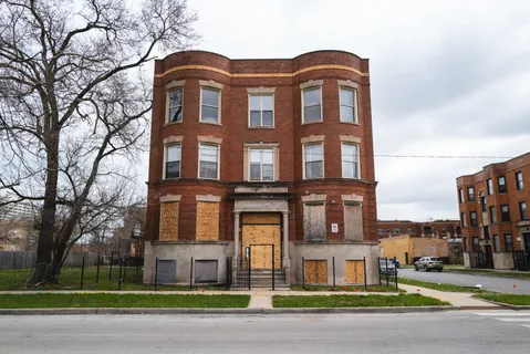 a front view of a residential apartment building with a yard