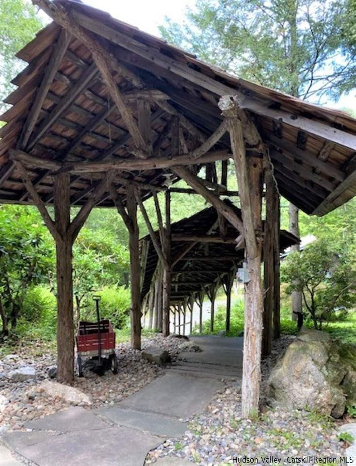 41 Stokes Way High Falls, NY 12440 - Photo 2 of 35 a view of a patio with table and chairs under an umbrella with a barbeque