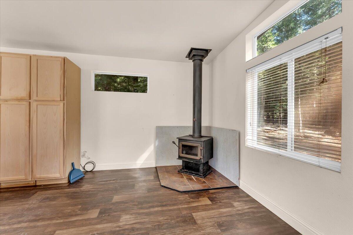 8495 Sky Tree Lane Shingletown, CA 96088 - Photo 12 of 55 a view of an empty room with wooden floor and windows