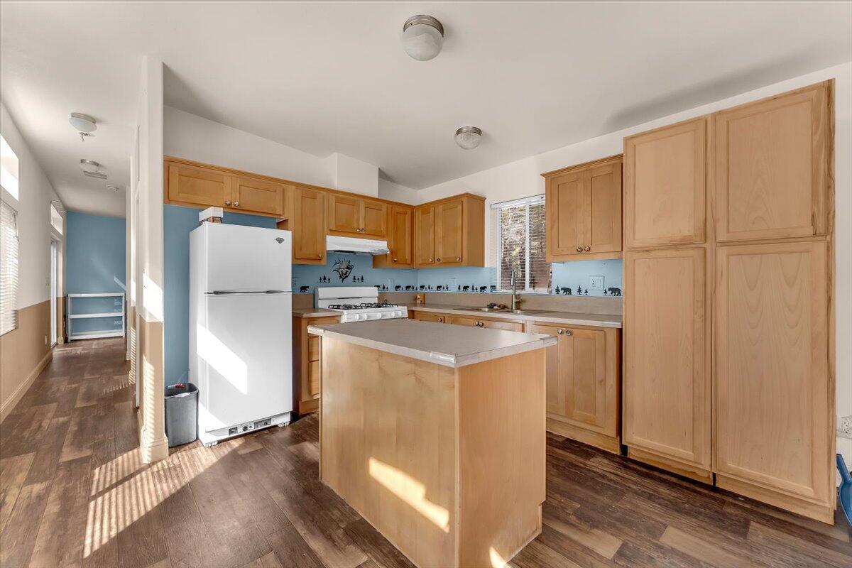 8495 Sky Tree Lane Shingletown, CA 96088 - Photo 15 of 55 a kitchen with stainless steel appliances granite countertop a refrigerator a sink and a stove with white countertops