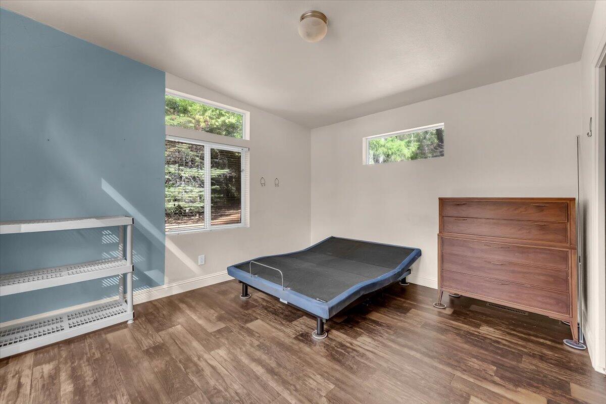 8495 Sky Tree Lane Shingletown, CA 96088 - Photo 18 of 55 a living room with a bed furniture and a window