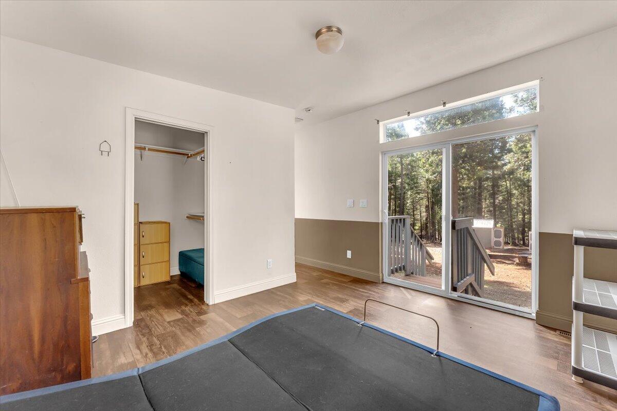 8495 Sky Tree Lane Shingletown, CA 96088 - Photo 19 of 55 a view of work space with wooden floor and windows