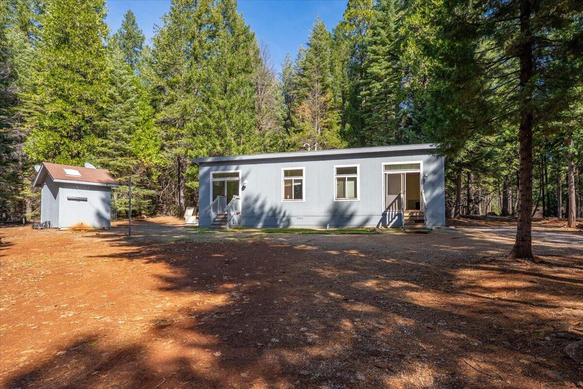 8495 Sky Tree Lane Shingletown, CA 96088 - Photo 2 of 55 a front view of a house with a yard and garage
