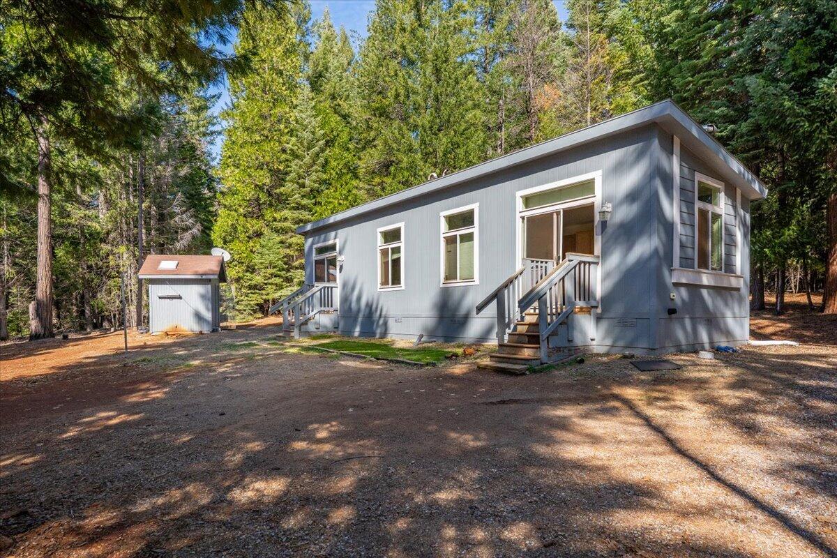 8495 Sky Tree Lane Shingletown, CA 96088 - Photo 5 of 55 a view of a house with backyard and trees
