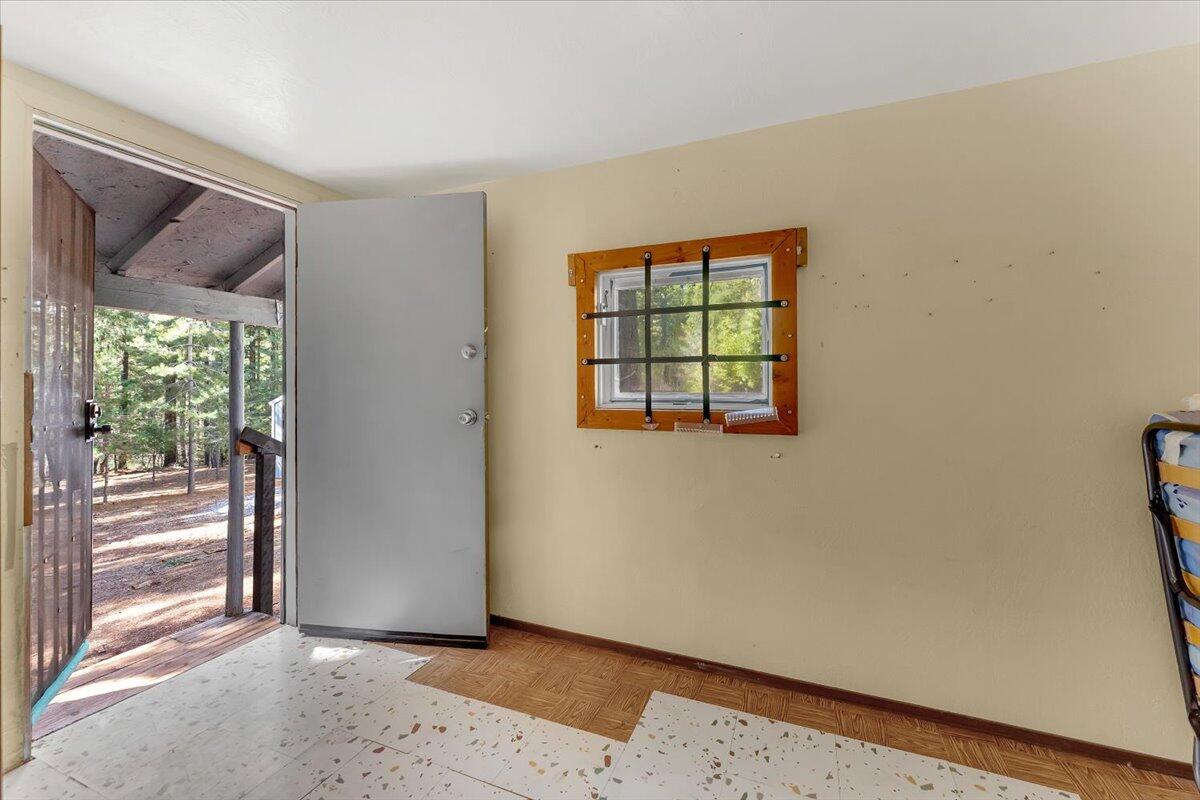 8495 Sky Tree Lane Shingletown, CA 96088 - Photo 7 of 55 a view of an empty room with a window