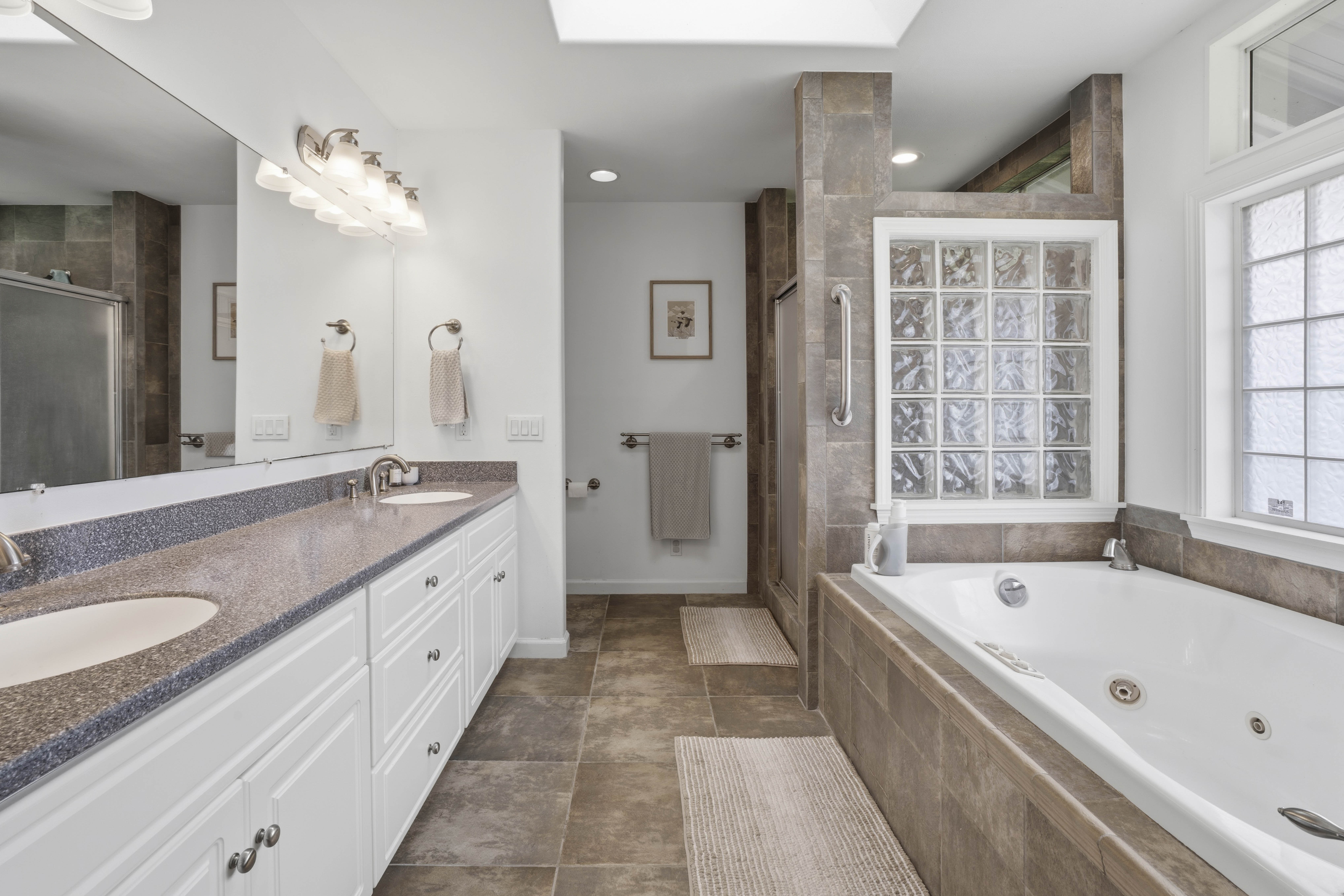 18-3970 Canney Road Mountain View, HI 96771 - Photo 2 of 30 a spacious bathroom with a granite countertop tub sink and mirror